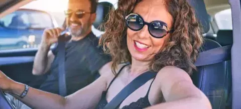 Hombre y mujer en el coche sonriendo